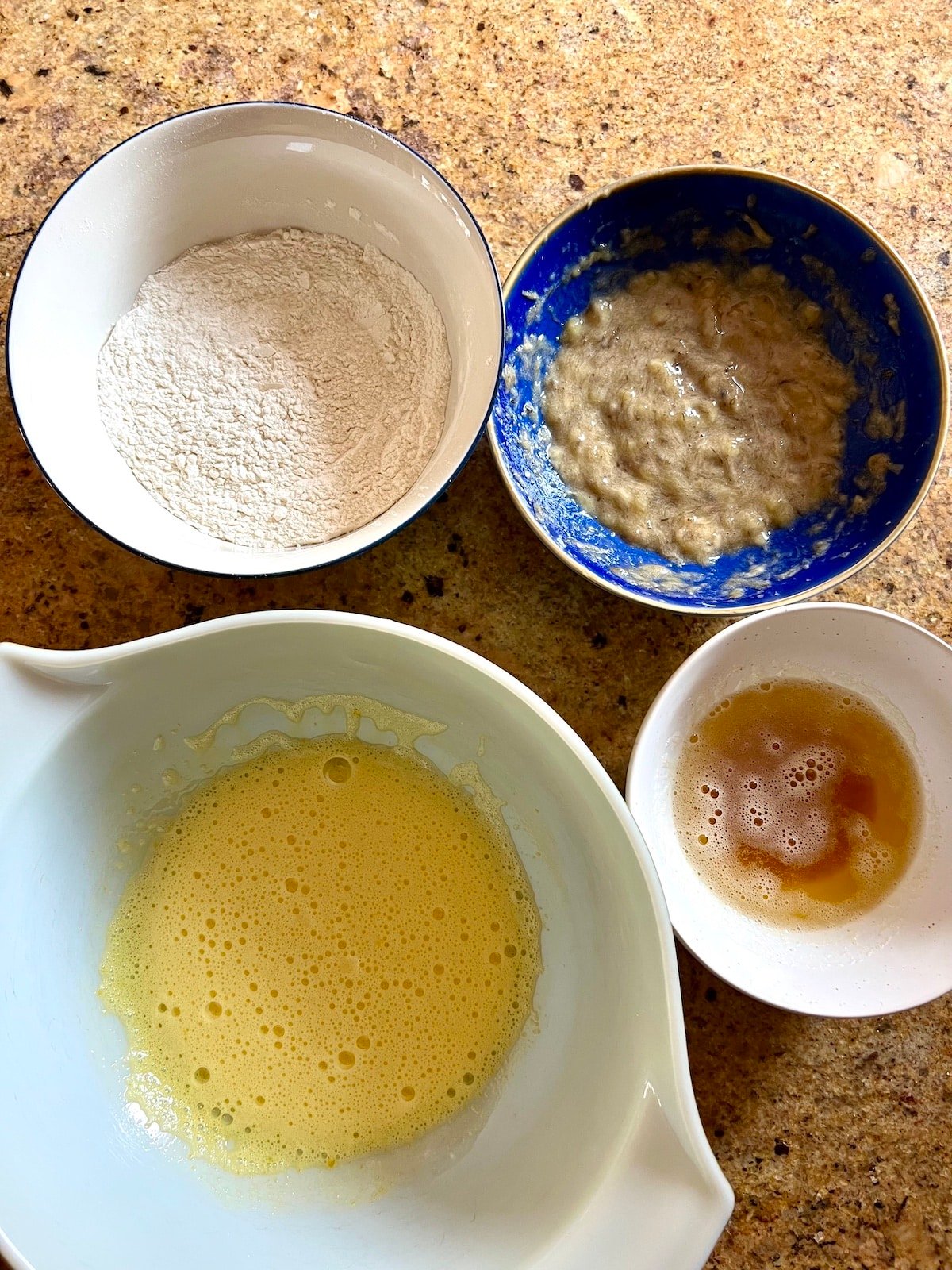 Various bowls with ingredients for the batter. 