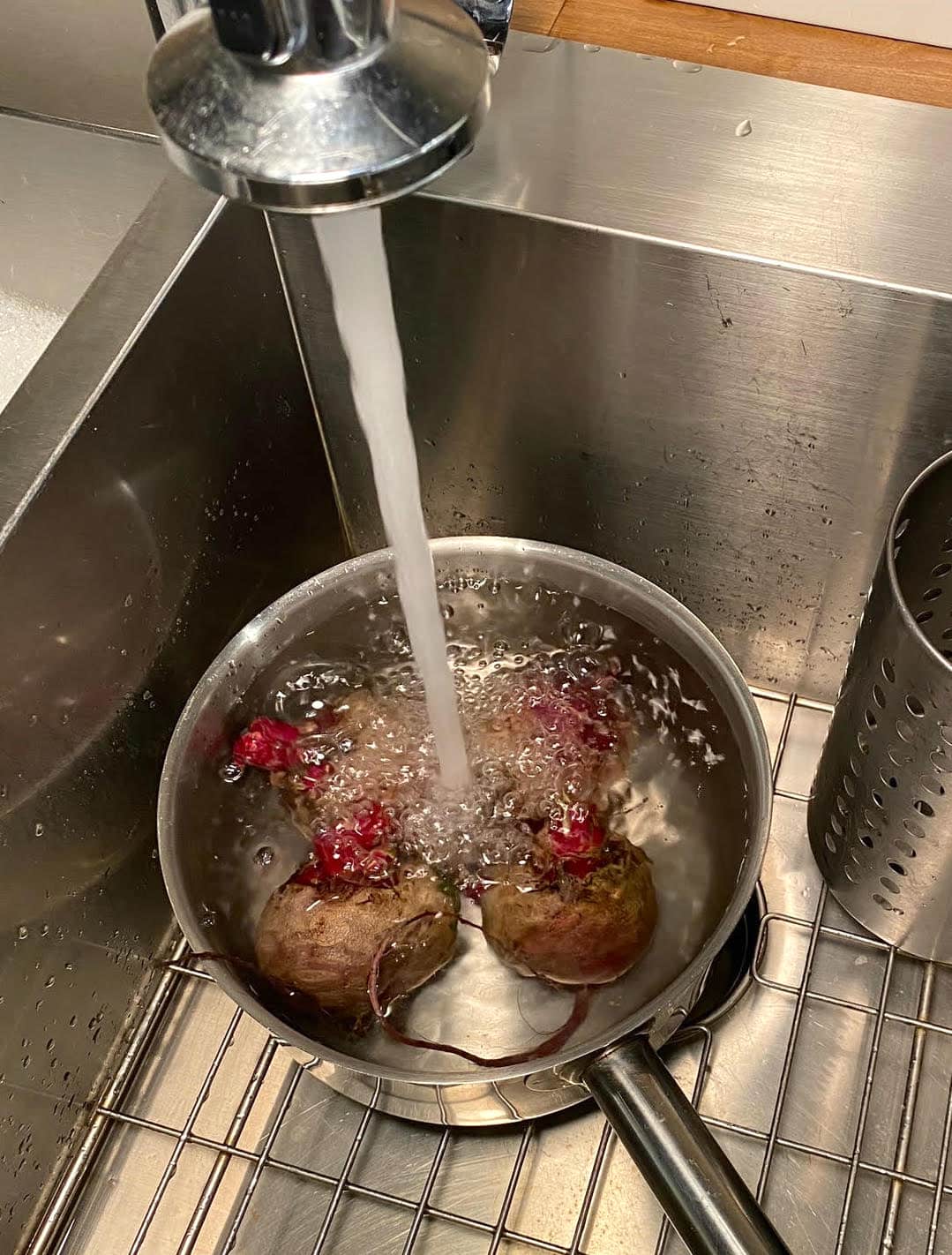Adding beets to a pot of water