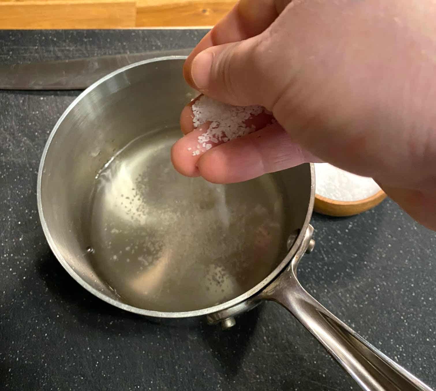 Adding salt to the pickled beets mix