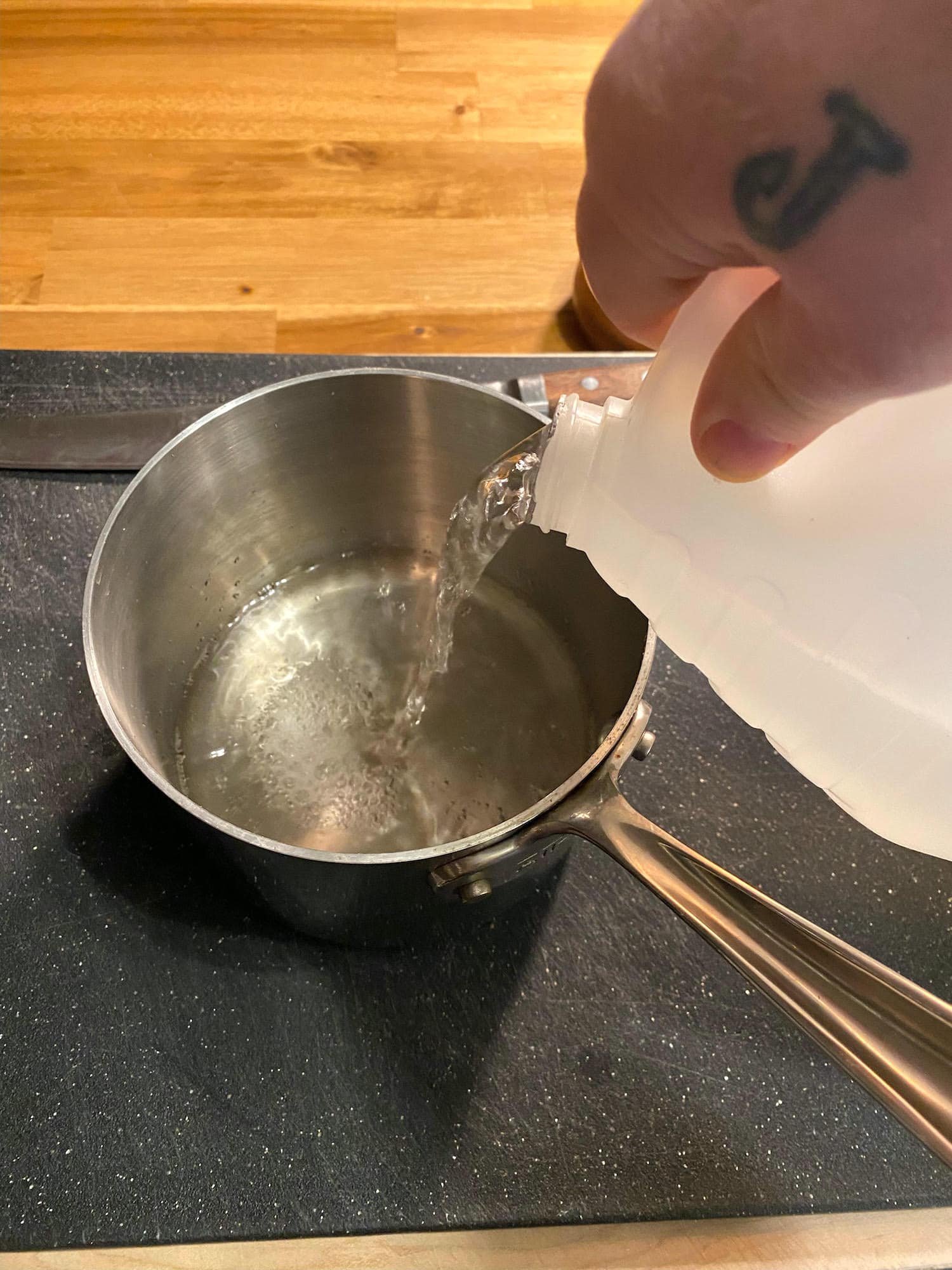 Adding vinegar to the pot