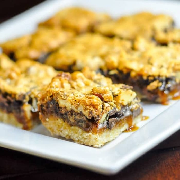 Chocolate Walnut Butter Tart Bars on a white serving plate