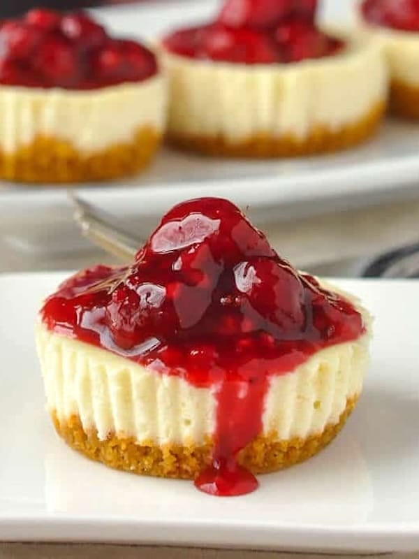 Mini Lemon Cheesecakes with Raspberry Sauce close up photo of one cheesecake.