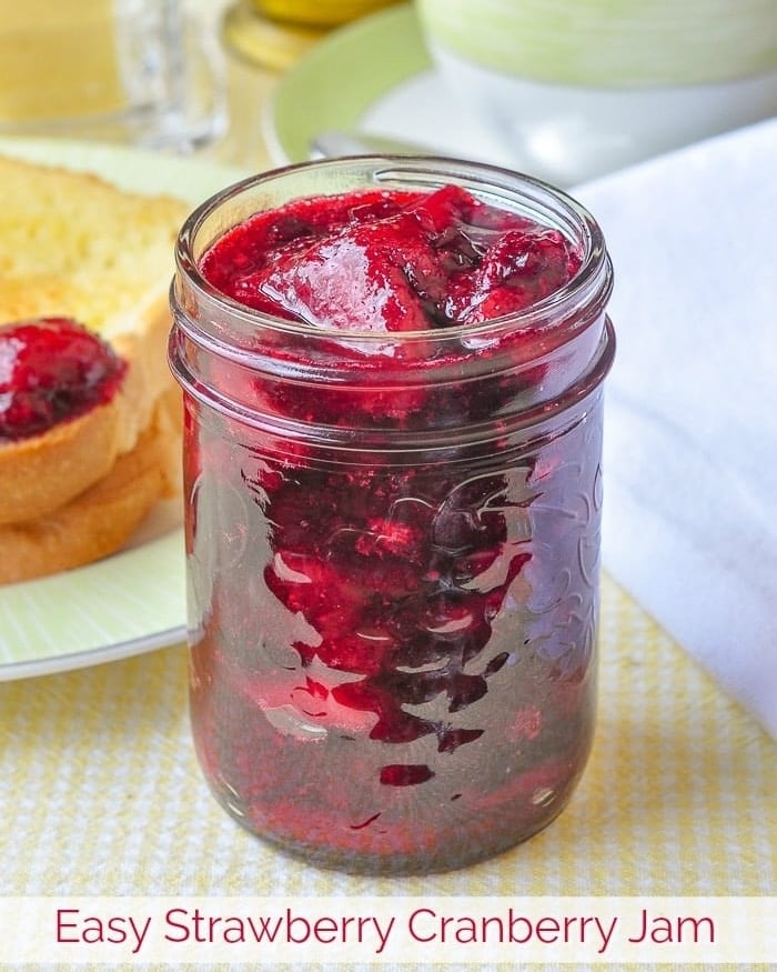 Strawberry Cranberry Jam photo of a single bottle of jam with title text added for Facebook and instagram