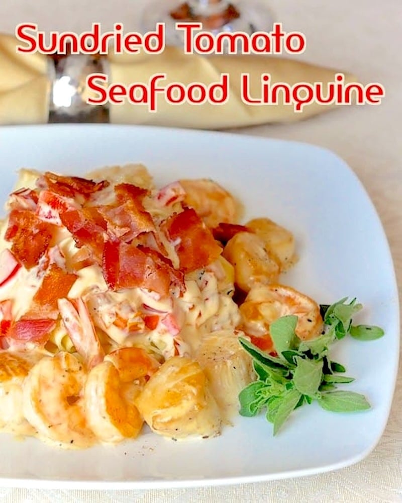 Sun Dried Tomato Seafood Linguine photo of one serving on a white plate with title text added for social media.