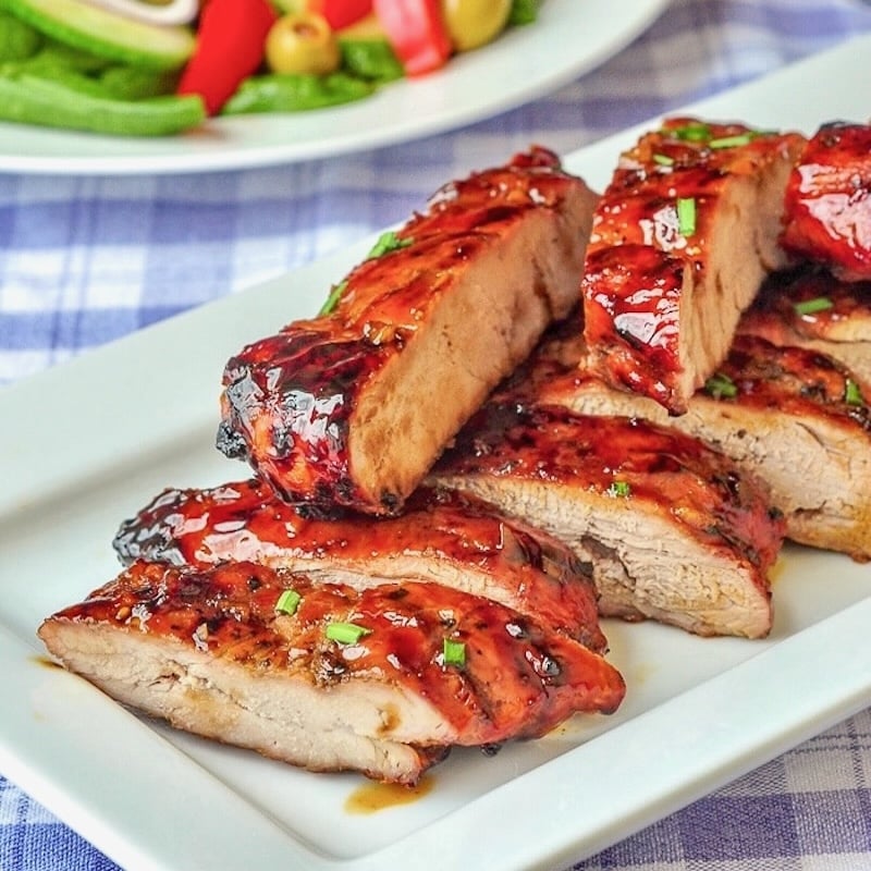 Low Fat Honey Garlic Boneless Ribs close up photo of cut ribs on a white serving platter.