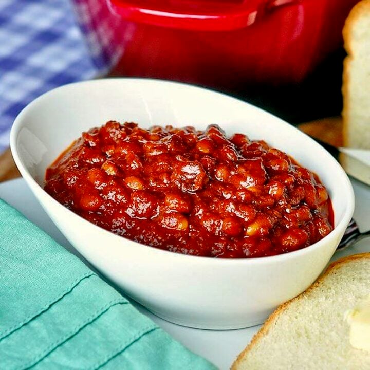 Bacon Brown Sugar Baked Beans close up photo of one serving in a white bowl.