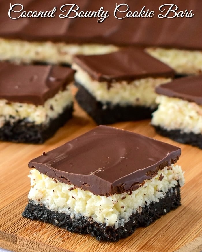 Coconut Bounty Cookie Bars photo of bars being cut on a wooden board with title text added for social media.