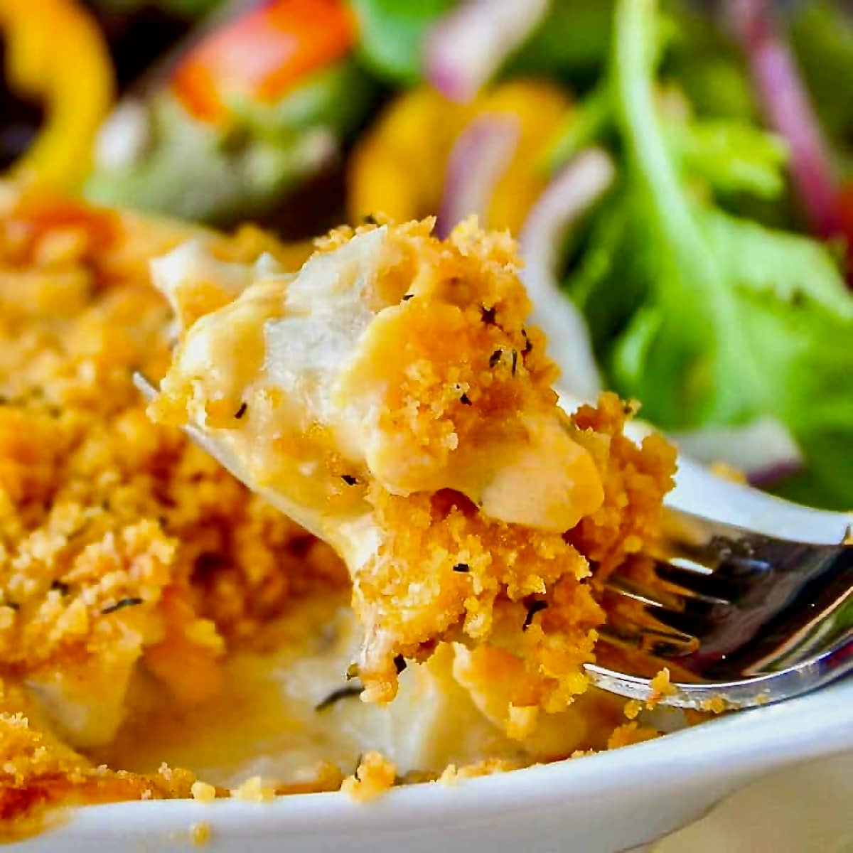 The Best Cod au Gratin close up photo of a bite if the dish on a fork.