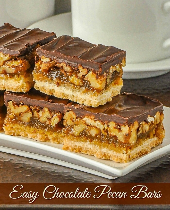 Chocolate pecan bars on a white platter with title text added for social media.