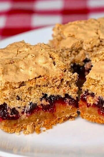 Partridgeberry Coconut Meringue Squares cropped featured image of cut squares on a white plate