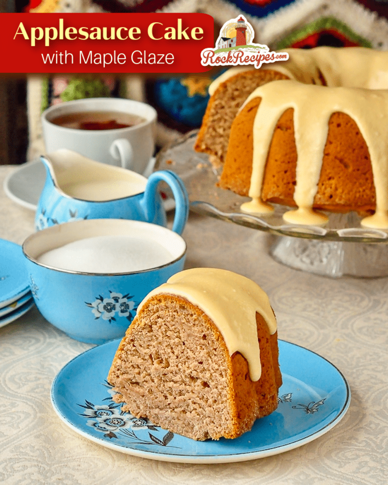 Applesauce cake photo of one slice with a blue tea service in background with title text added for social media posts.