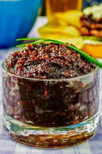 Beer and Bacon Jam in a clear glass serving dish square cropped for Google featured image.