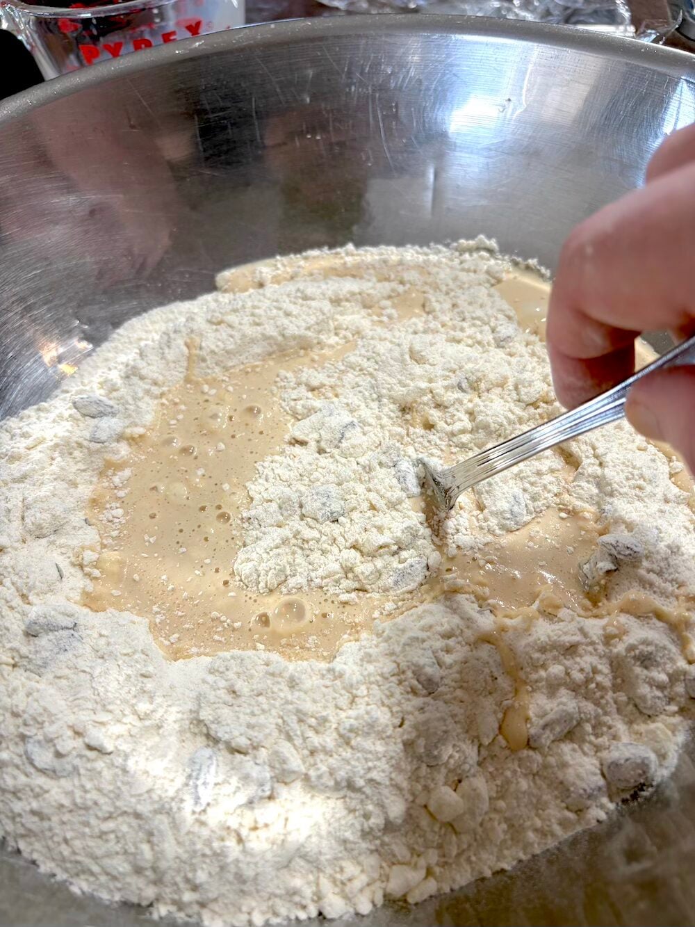 Using a fork to combine the ingredients.