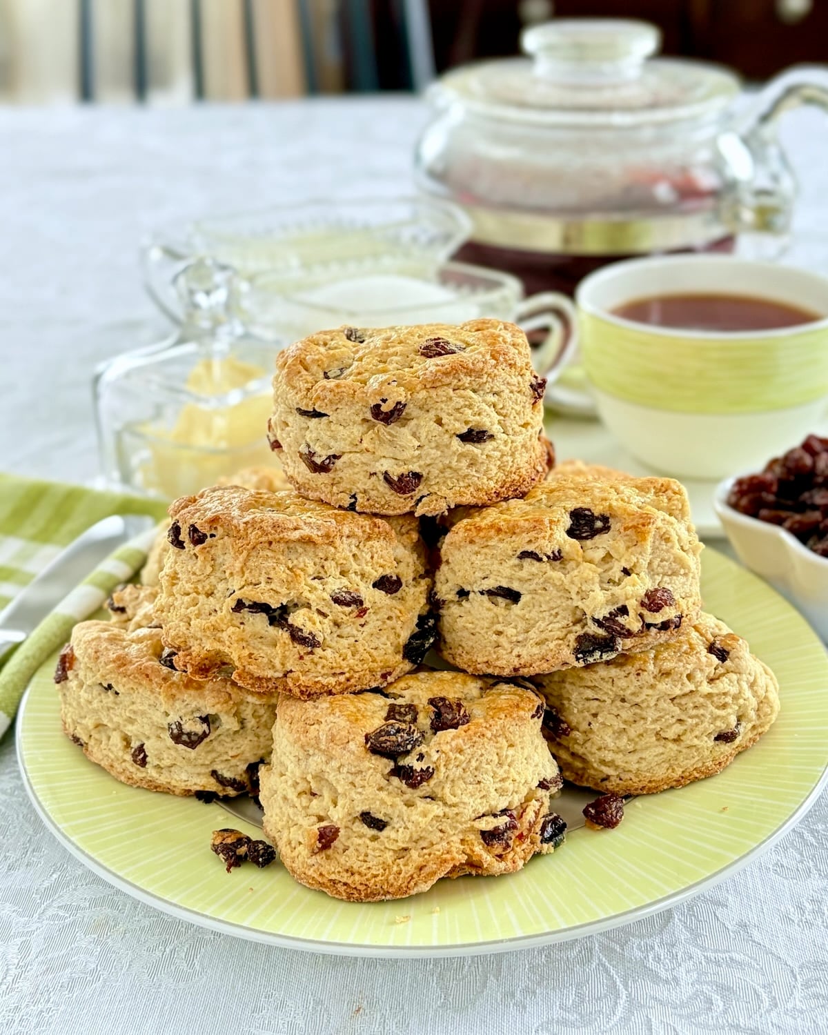 Newfoundland Raisin Buns. vertically cropped photo od stacked buns being served with tea.
