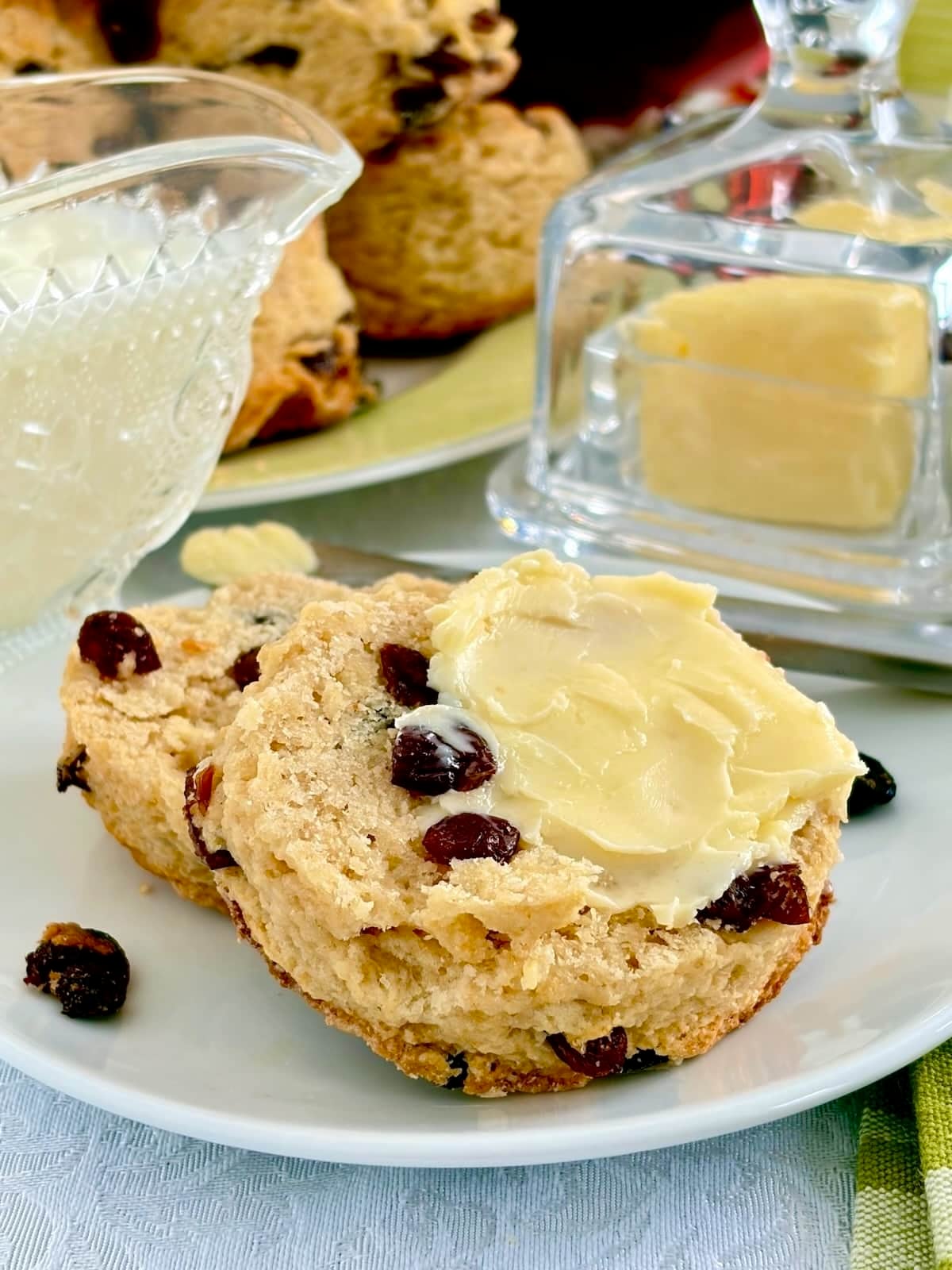 Vertically shot photo of a tea bun split in half and buttered,