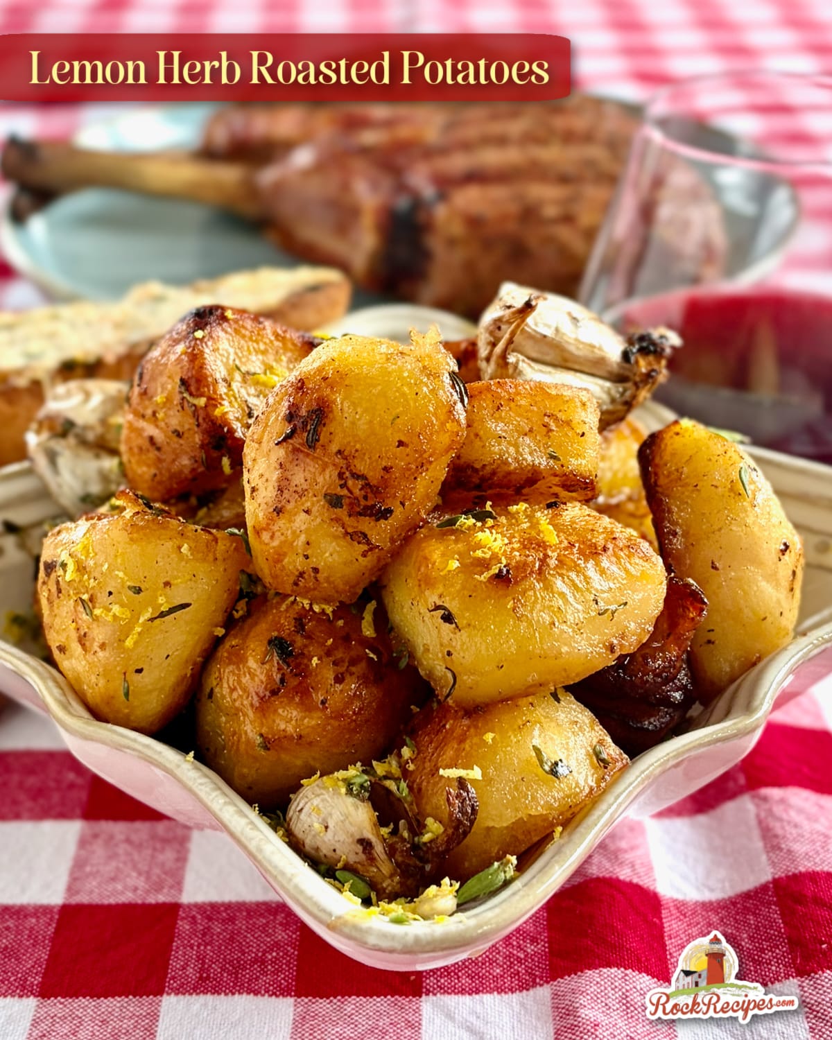 Lemon Herb Roasted Potatoes in a square bowl on a red checkered table cloth. with title text for social media.