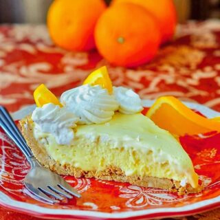 Orange Creamsicle Pie photo of single slice on orange patterned plate.