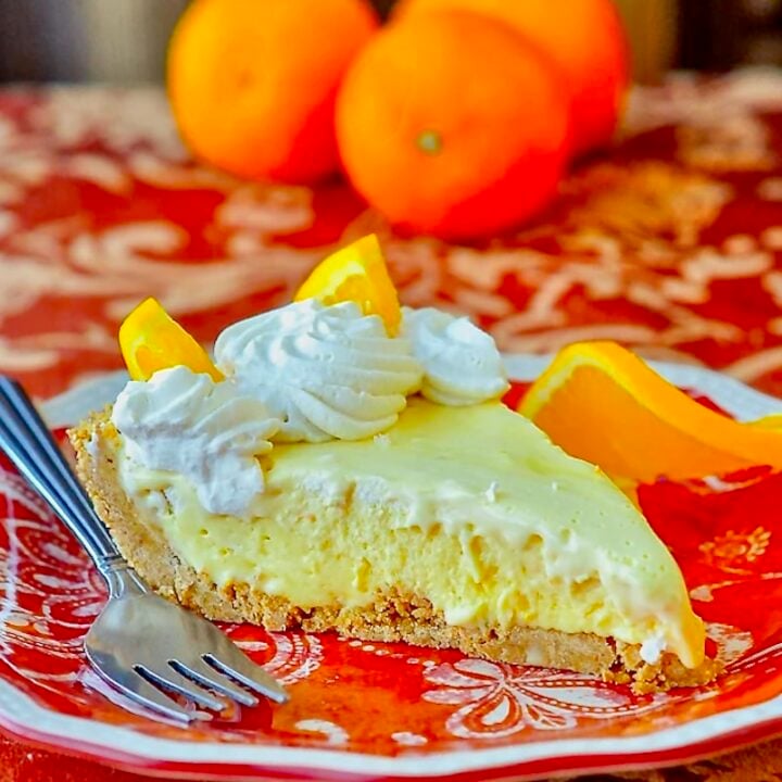 Orange Creamsicle Pie photo of single slice on orange patterned plate.