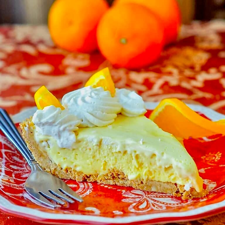Orange Creamsicle Pie photo of single slice on orange patterned plate.
