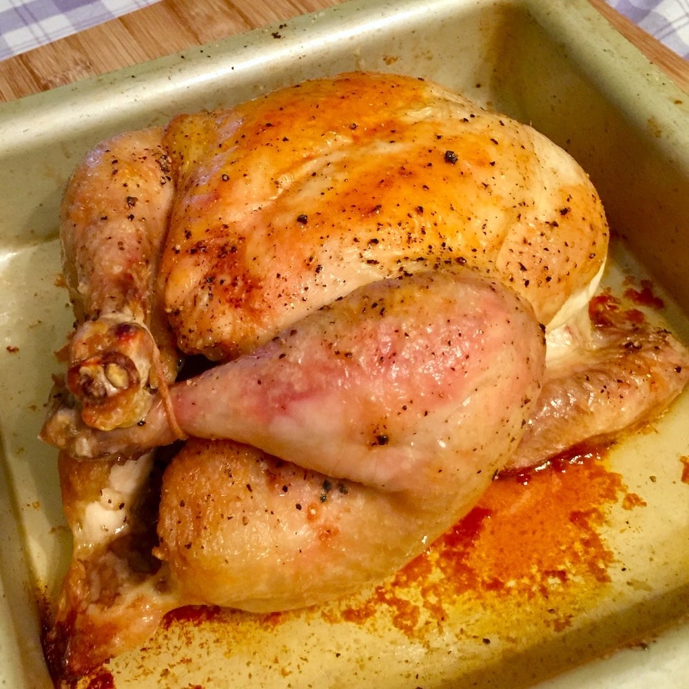 Open roasted turkey being cooked in a roasting pan.