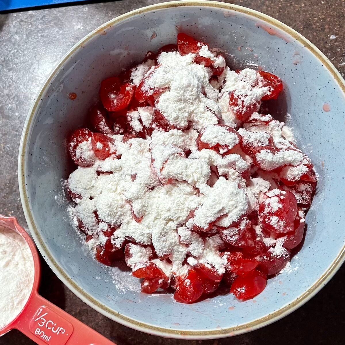 Adding flour to the cherries.
