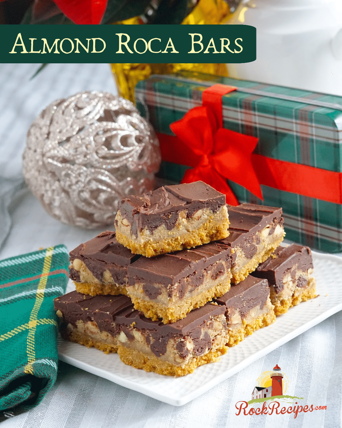 Almond Roca Cookie Bars. Stacked on a white plate with christmas decoration background with title text added for social media.