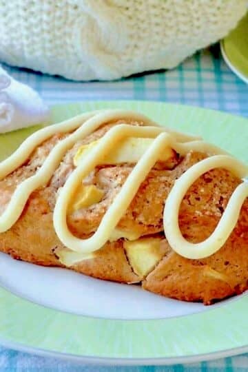 Apple Cinnamon Scones with Cream Cheese Glaze, photo of a scone on a green and white plate close up photo for featured google image.