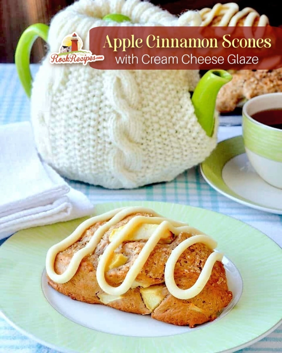 Apple Cinnamon Scones with Cream Cheese Glaze, photo of a scone on a green and white plate with coffee service in the background with title text and Rock Recipes logo added for Pinterest and social media posts.