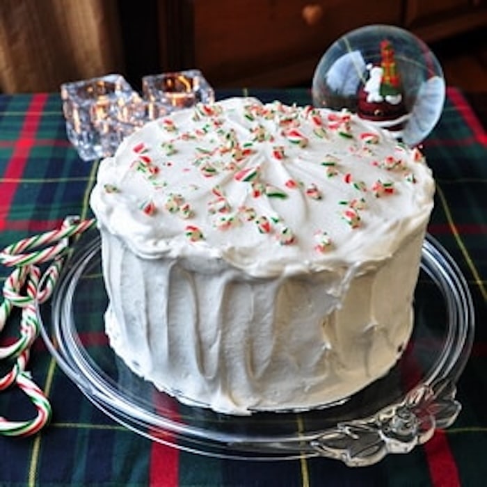 Candy Cane Cake photo of entire cake frosted, ion a clear glass cake plate.