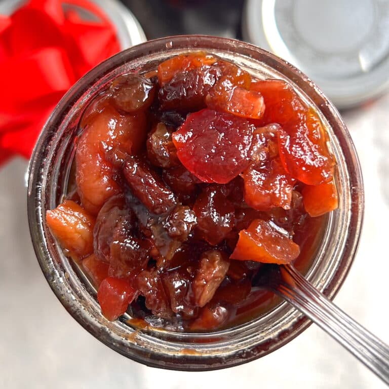 Jamaican Black Cake fruit preparation overhead shot of open bottle