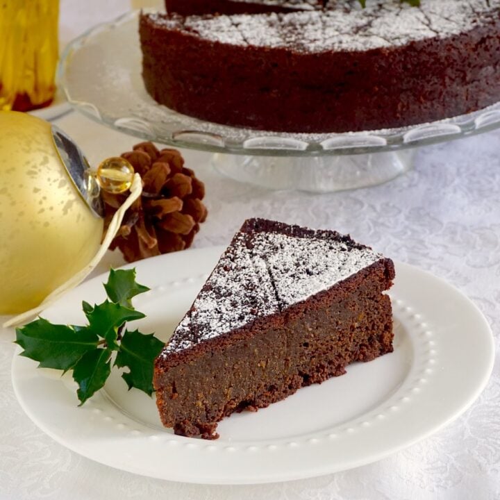 Newfoundland Jamaican Black Christmas Cake close up photo of one slice on a white plate for Google featured image