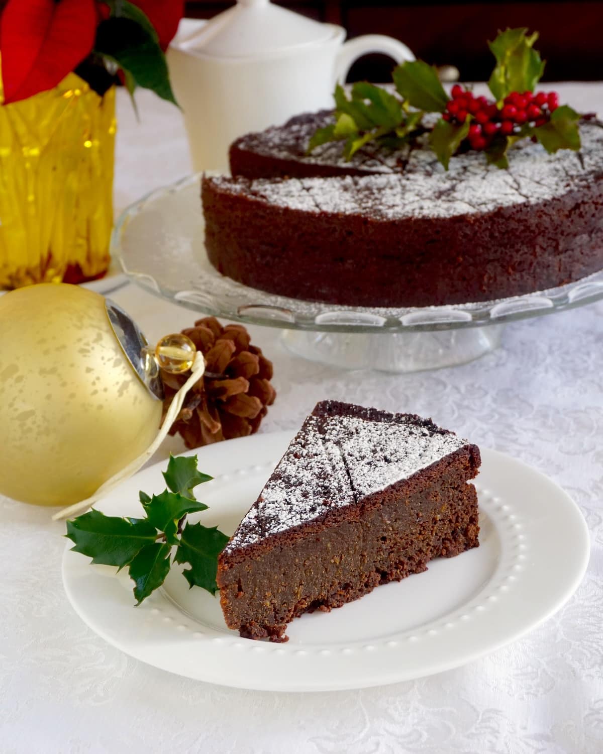 Newfoundland Jamaican Black Christmas Cake wide shot of one slice with whole cake in background