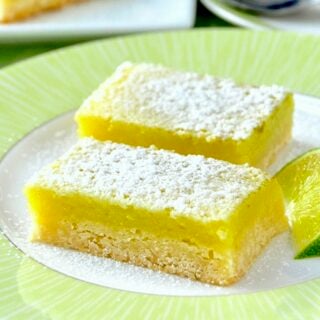 Super Easy Lime Bars with lime wedge on a green and white plate