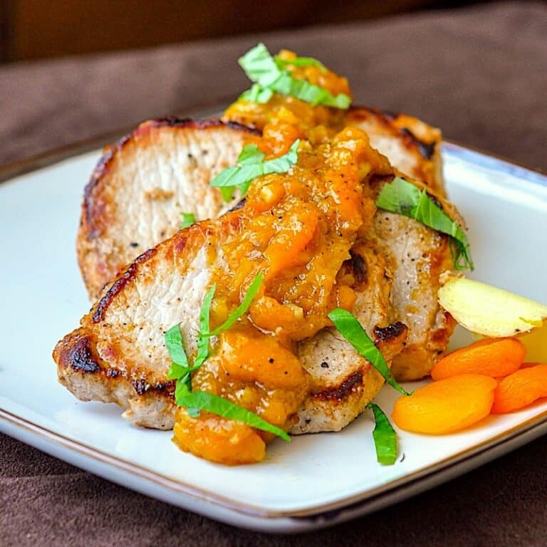 Apricot Ginger Chutney on Pan Seared Pork Chops shown on a square ceramic serving platter