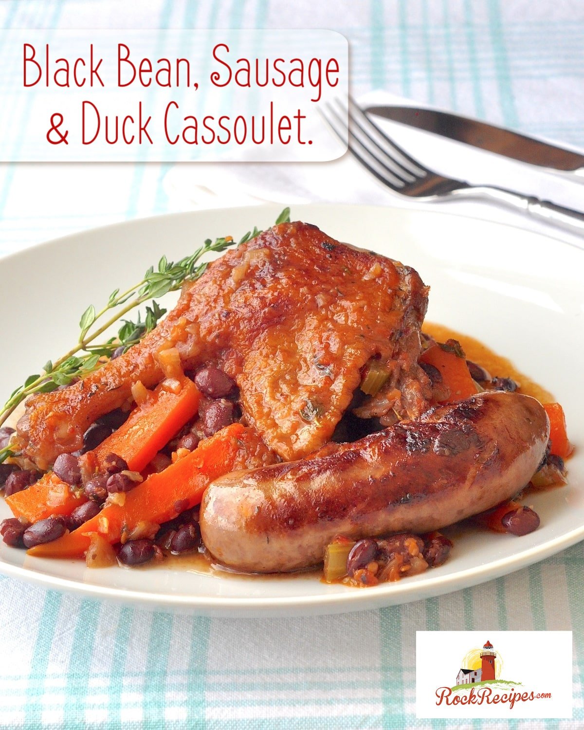 Black Bean, Sausage & Duck Cassoulet one serving pictured in a white bowl with title text added for social media