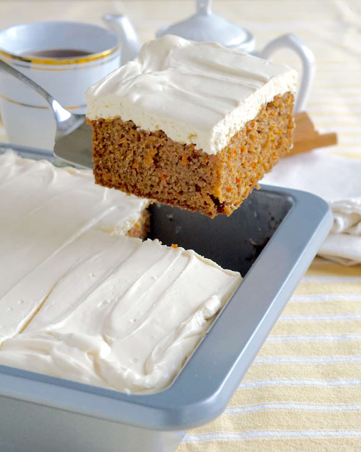 Quick Carrot Cake photo of a single slice being lifted from the baking pan.