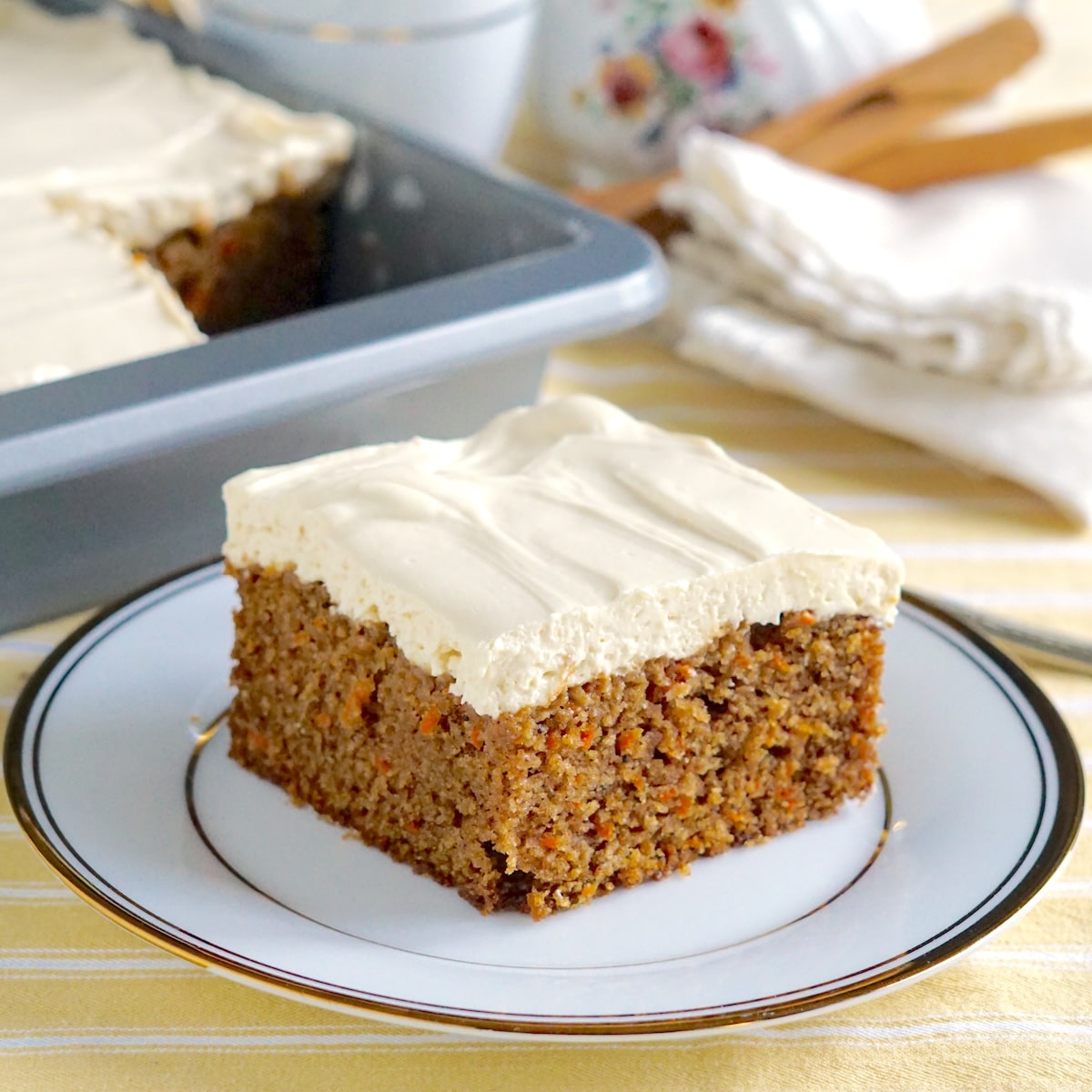 Close up photo of One slice of Quick Carrot Cake on a gold trimmed plate, cropped for Google featured image.