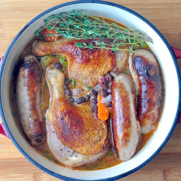 Black Bean, Sausage & Duck Cassoulet shown in a cast iron dutch oven.
