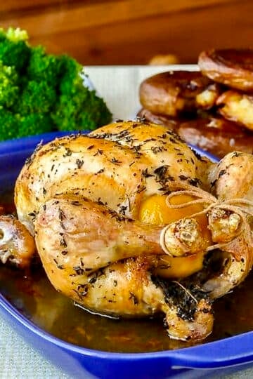 Lemon Thyme Roast Chicken, just out of the oven on a blue ceramic roasting tray for Google featured image.