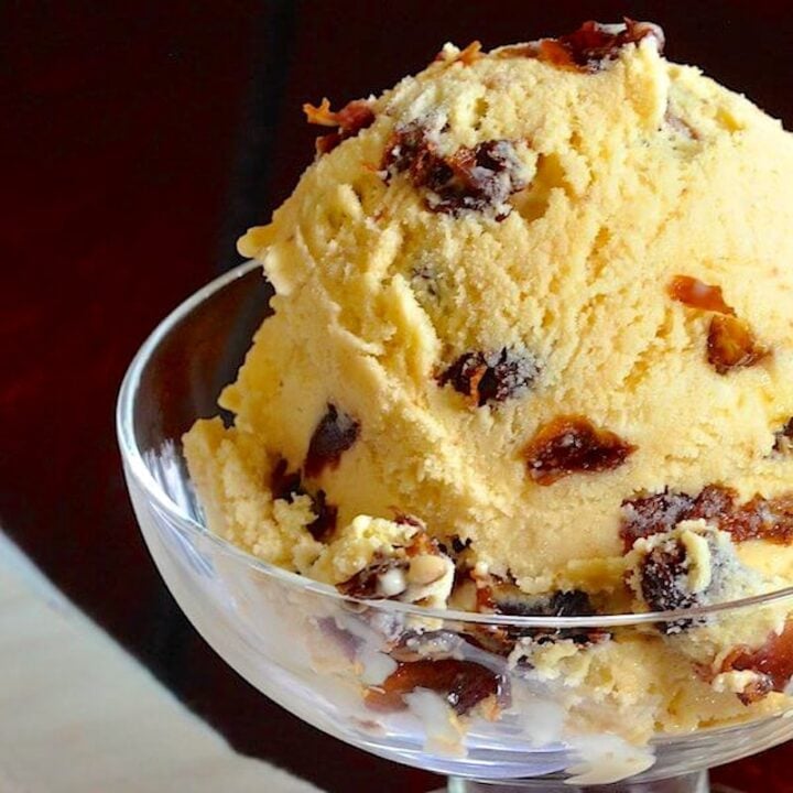 Rum Raisin Ice Cream close up photo of one scoop in a glass dish formatted as featured Google image.