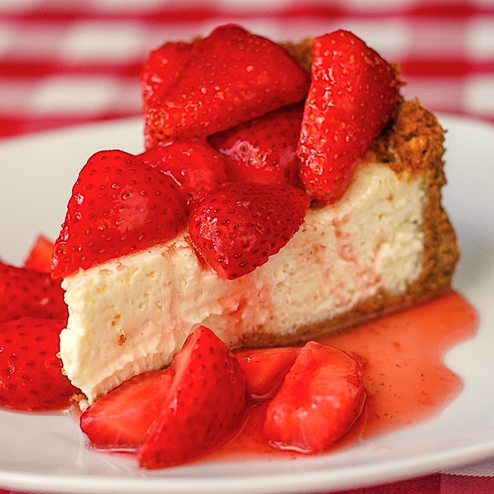 Strawberry Cointreau Sour Cream Custard Flan photo of single slice on a white plate for featured Google image.