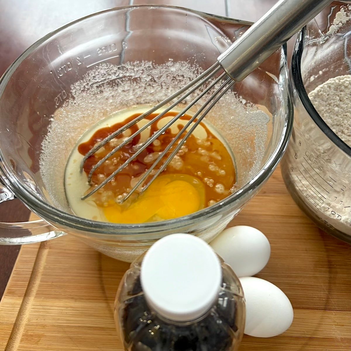 Whisking the sugar, eggs, oil and vanilla.