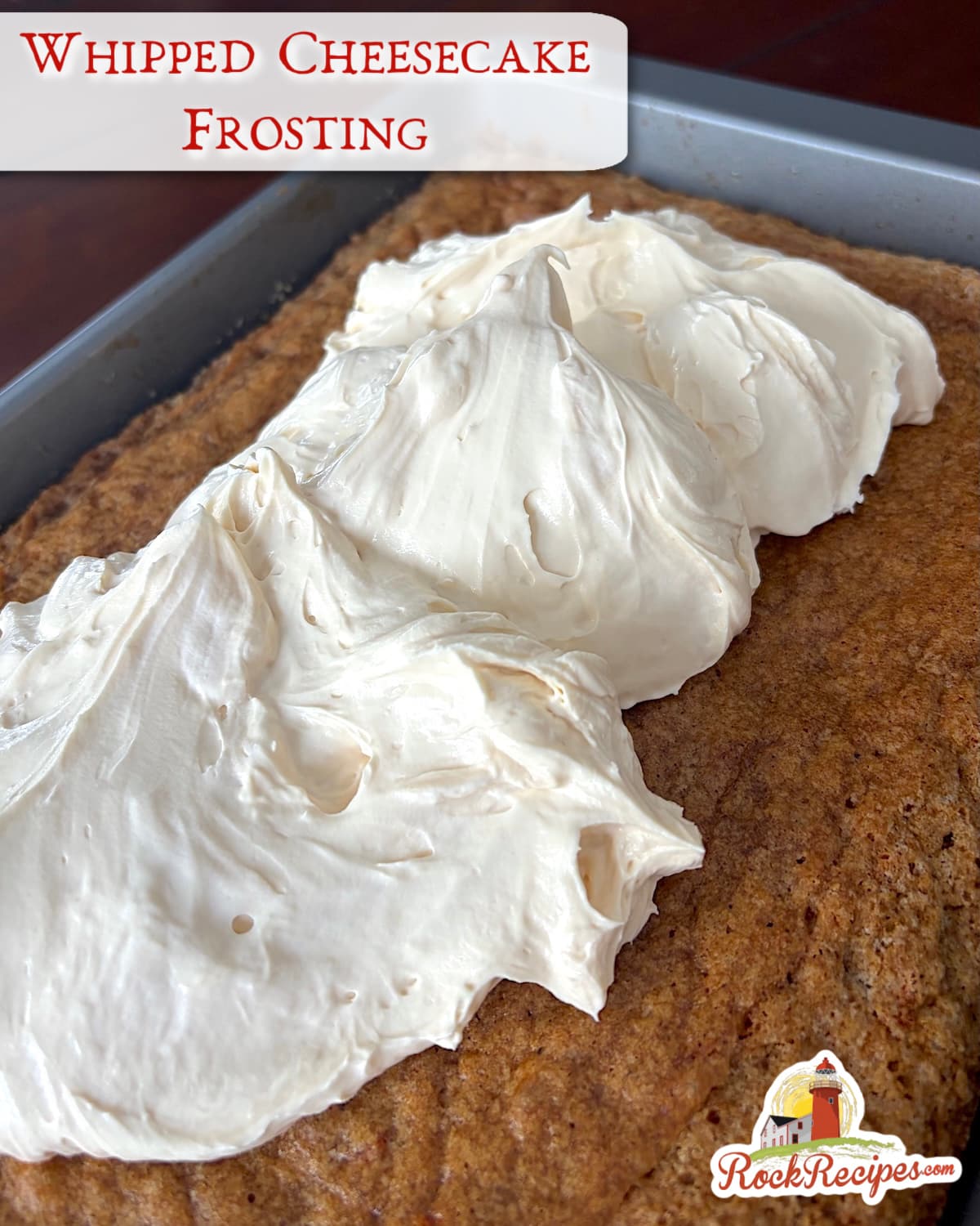 Whipped Cheesecake Frosting being spread on a slab carrot cake. Photo with title text added for social media posts.