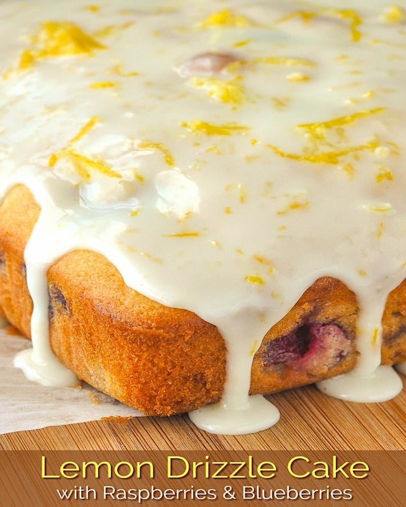 Lemon Drizzle Cake photo of uncut cake on a wooden cutting board with title text added for social media.