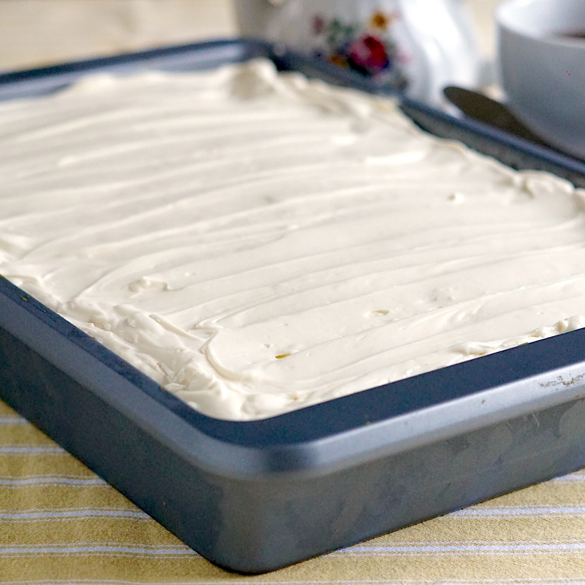 Quick Carrot cake frosted in a baking pan.