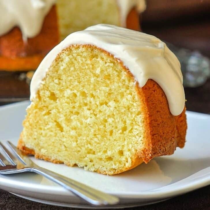 Vanilla Cream Cheese Bundt Cake close up photo of a single slice on a white plate