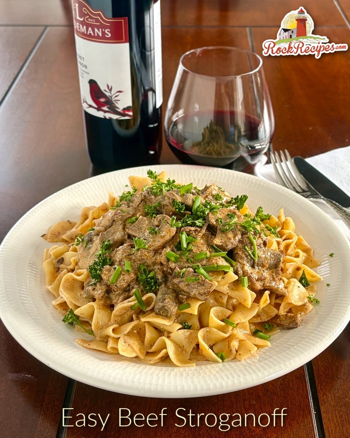 Beef Stroganoff photo of one serving on a white plate with title text and logo added for Pinterest and social media.