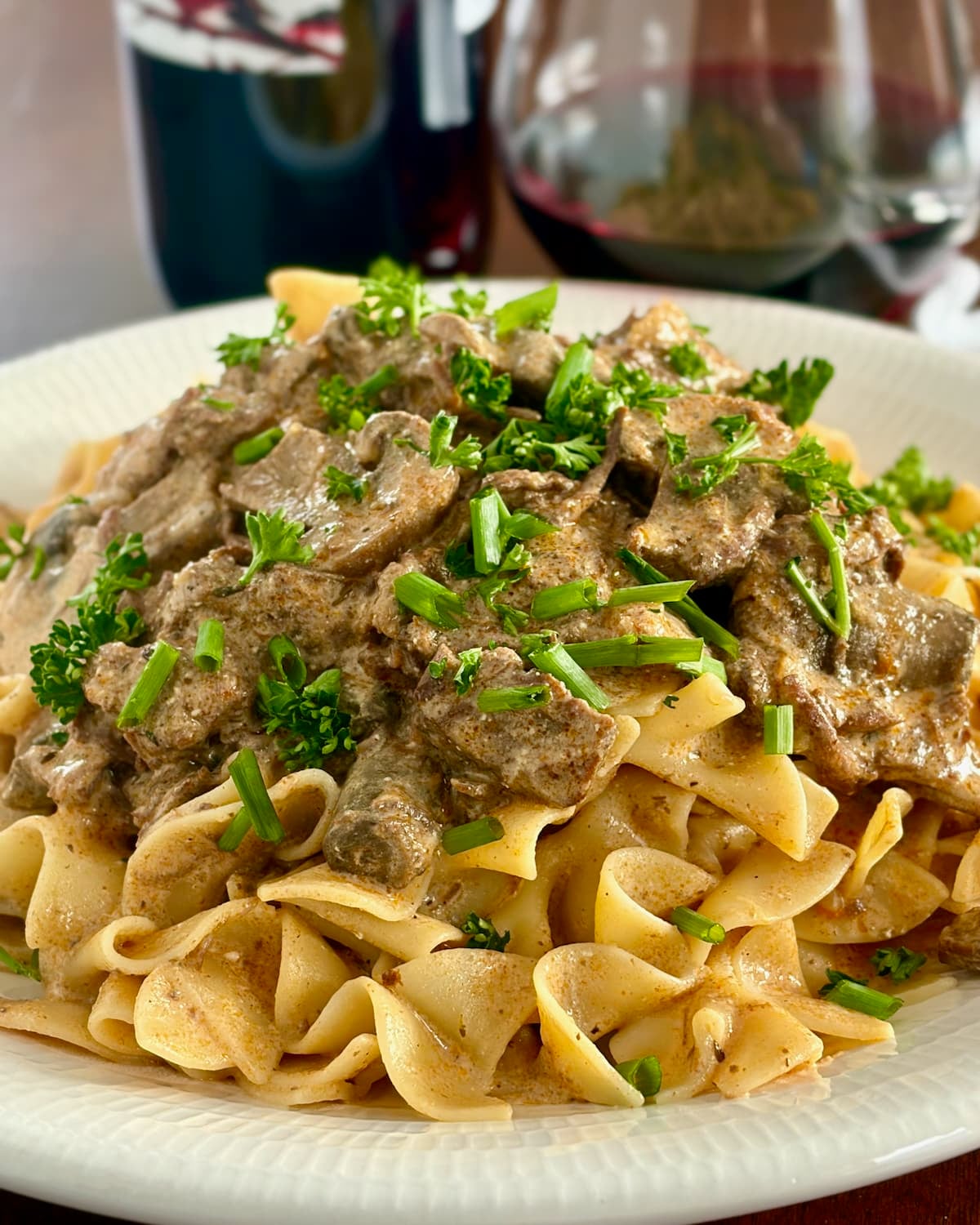 Close up photo of Beef Stroganoff photo of one serving on a white plate