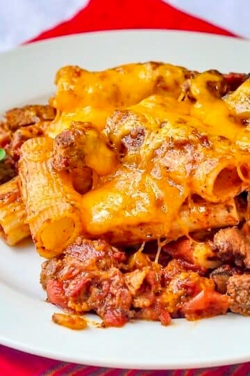 Cheesy Steak & Bacon Baked Pasta close up image of single serving on a white plate