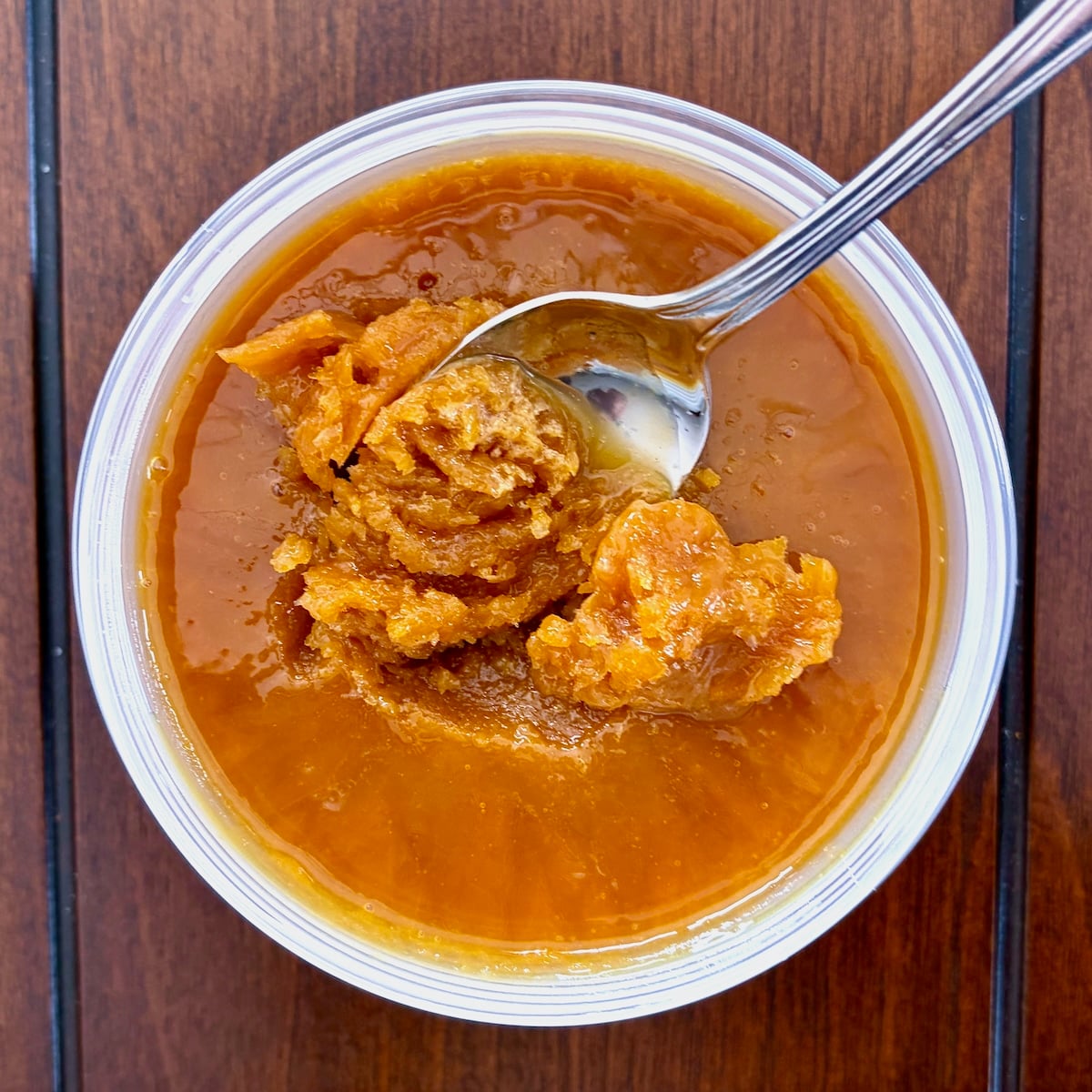 Homemade Orange Juice Concentrate overhead shot of spoon in frozen concentrate